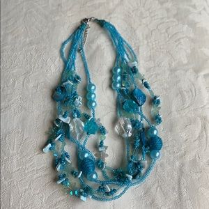A blue recycled necklace.